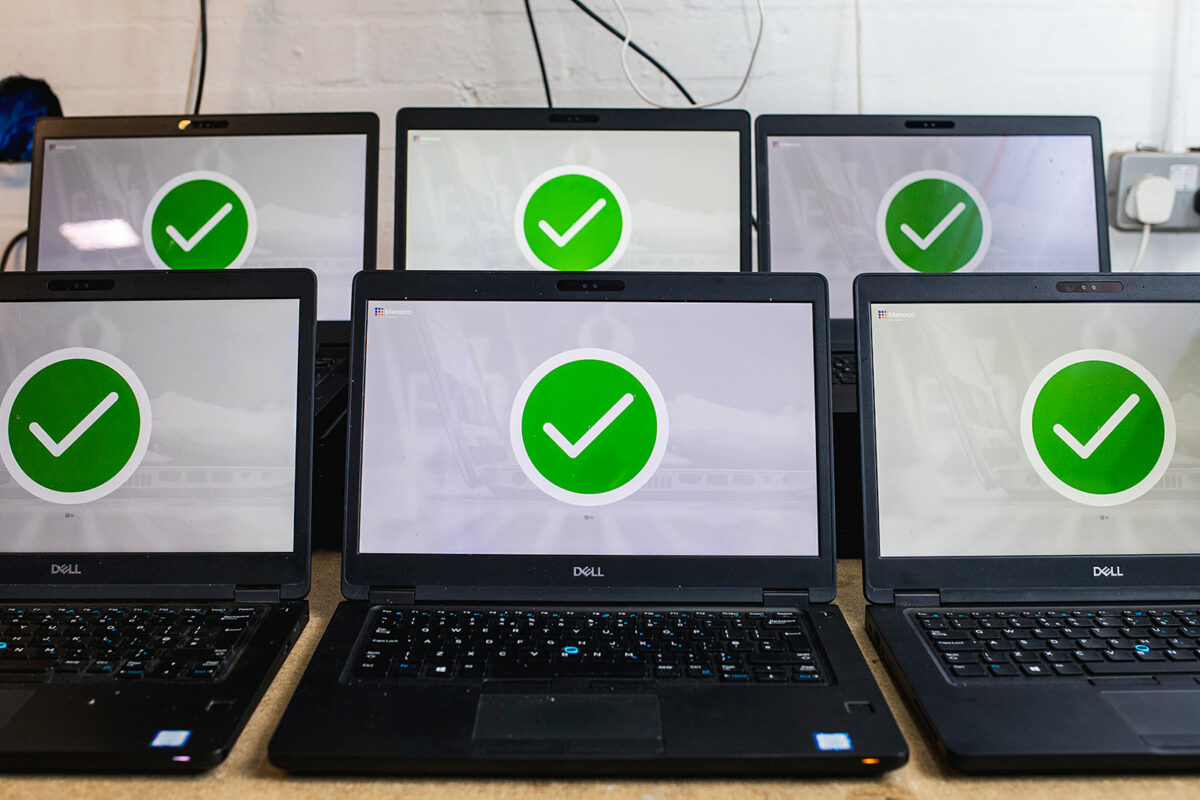 6 Dell laptops showing checkmarks on their display